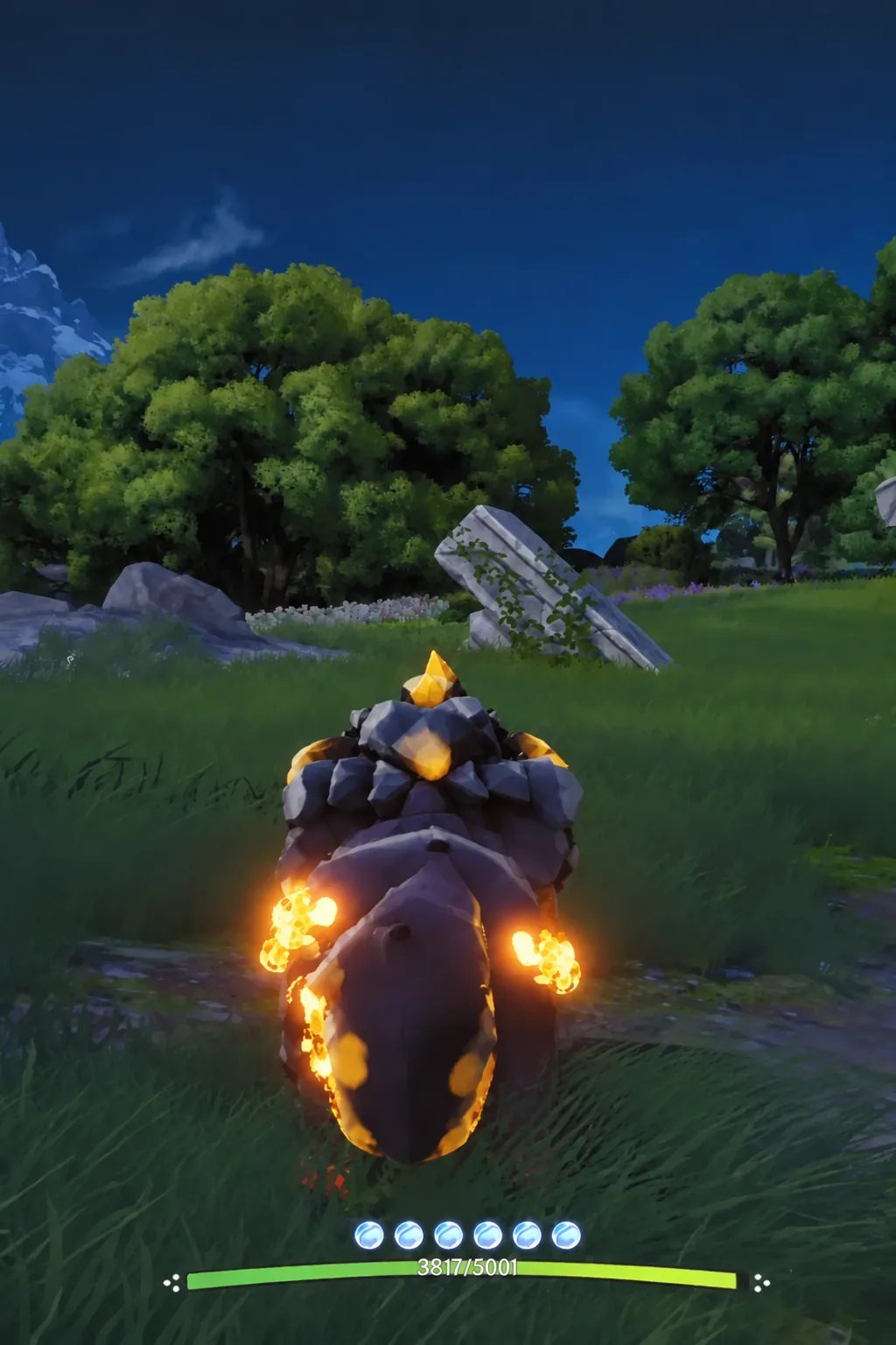A flaming rock creature rolling across open grassland with the combat HUD visible