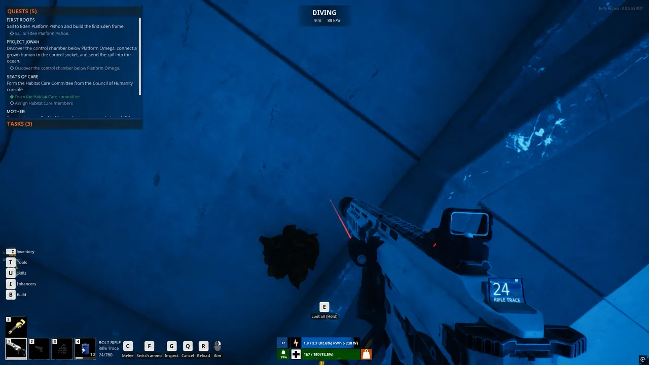 Gameplay HUD showing the hold-E loot all prompt over a killed creature underwater