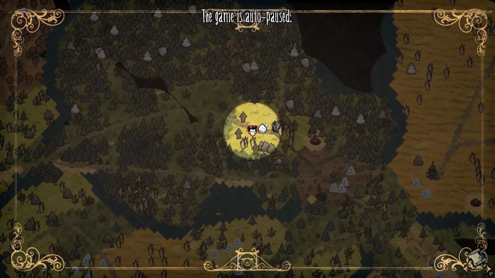 The auto-paused message displayed over the world map screen