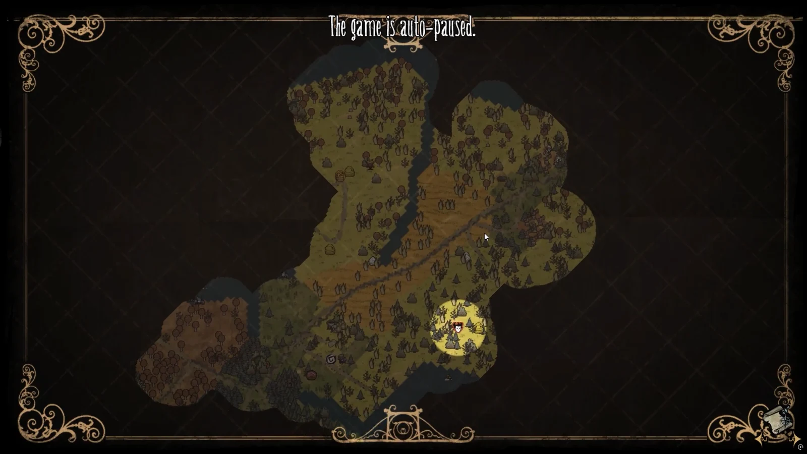 The auto-paused world map with the player's position lit up in a small explored patch