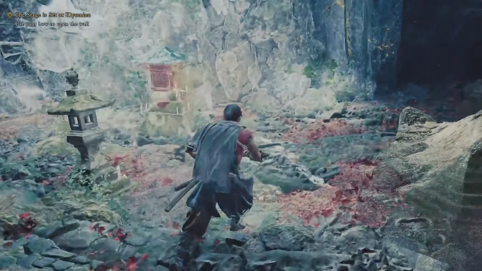 Objective prompt telling the player to use the bow to open the wall near a rocky section