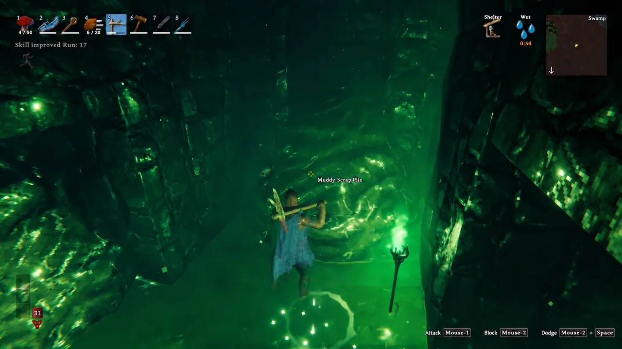 Player swinging at a highlighted Muddy Scrap Pile deep in a Valheim crypt tunnel