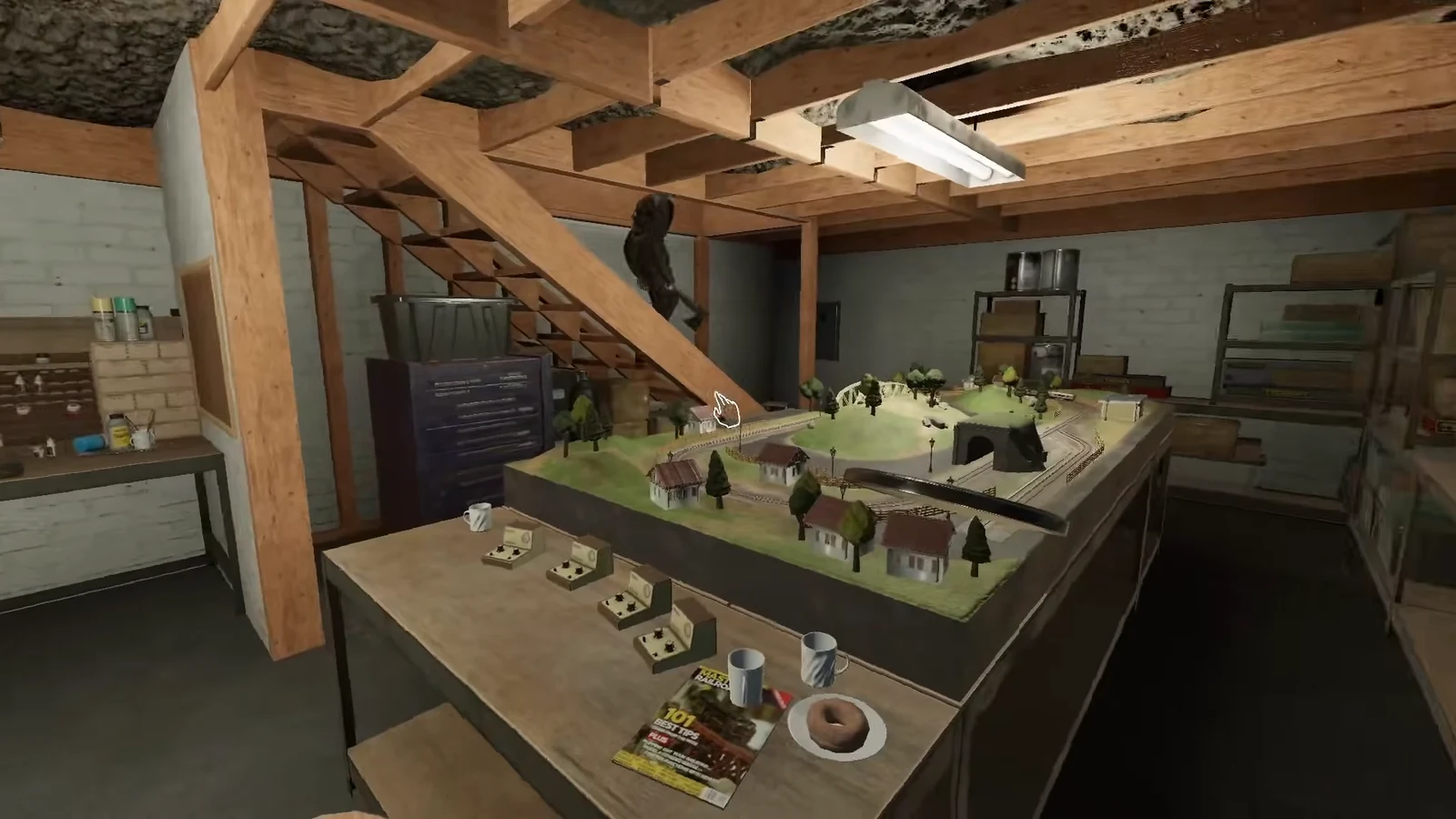 Cursor over a large model train table in a workshop, usable as a looping obstacle