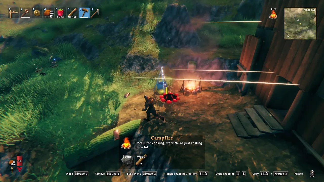 A lit Campfire burning directly beneath a Cauldron in Valheim
