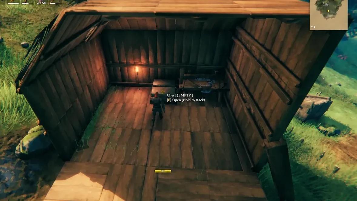 The Chest (EMPTY) prompt in Valheim showing the E Open (Hold to stack) interaction hint