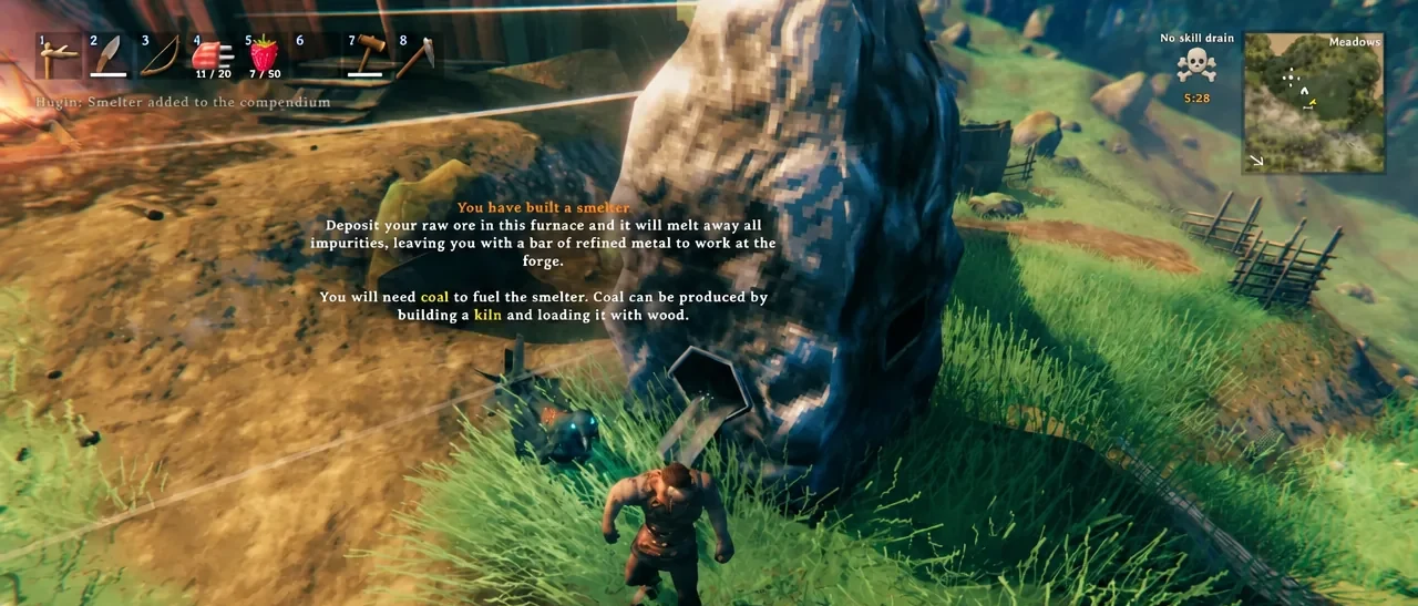 In-game tutorial popup confirming the smelter has been built and explaining ore deposits