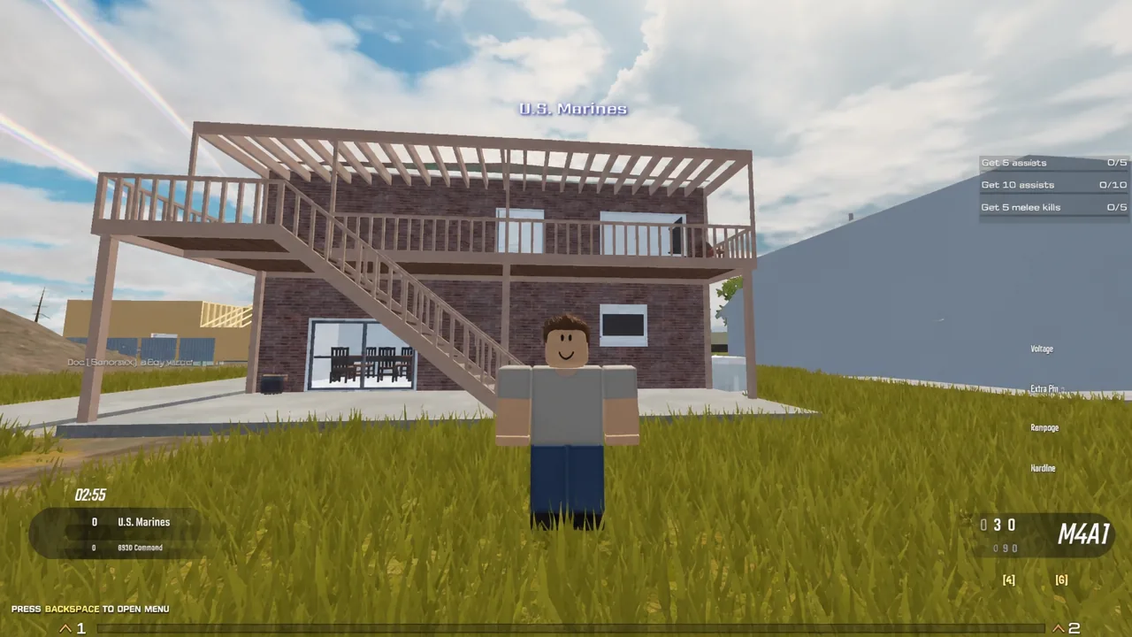 Player spawns on the U.S. Marines side holding an M4A1 outside a two-story house