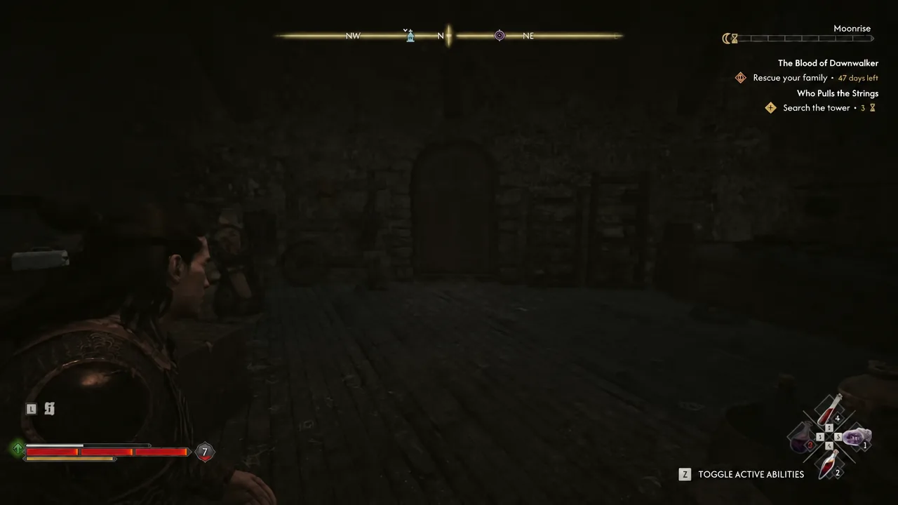 Coen exploring the dark ground floor of Aurelius's Tower with the quest objective on screen