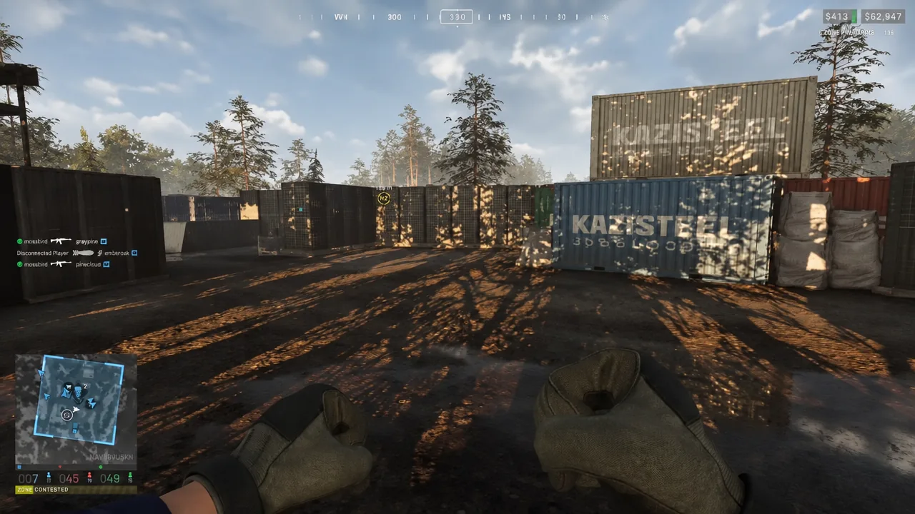 First-person view at the frontline facing a container yard with the HZ objective marker ahead