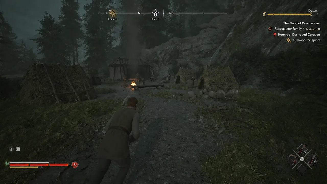 Coen crouching along a path toward a lit campfire in the bandit camp