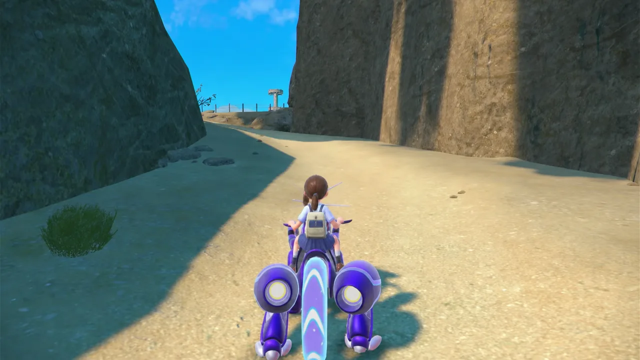 Player riding Miraidon through the desert canyons of East Province on the way to the Steel Titan