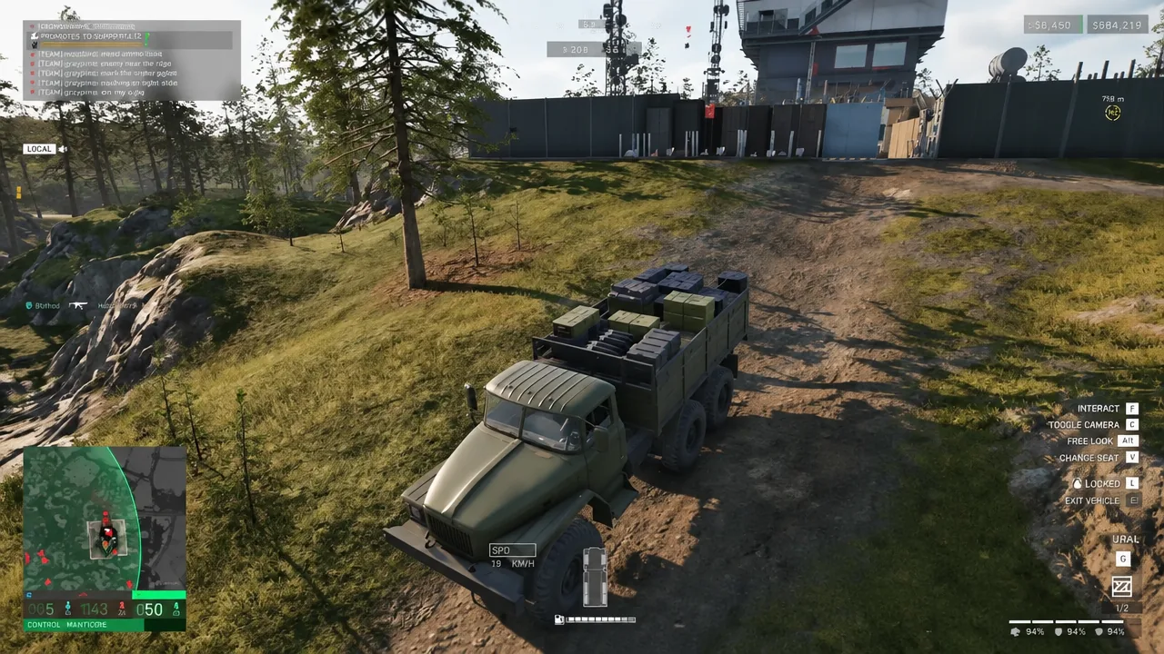 Ural truck driving back through the base gates with vehicle control prompts on screen