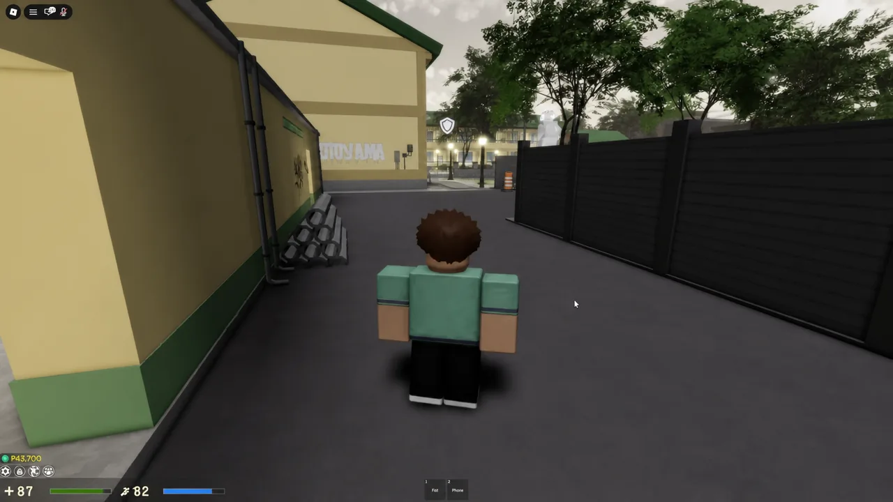 Klase avatar moving down an alley toward a shield-marked area with Fist and Phone slots on screen