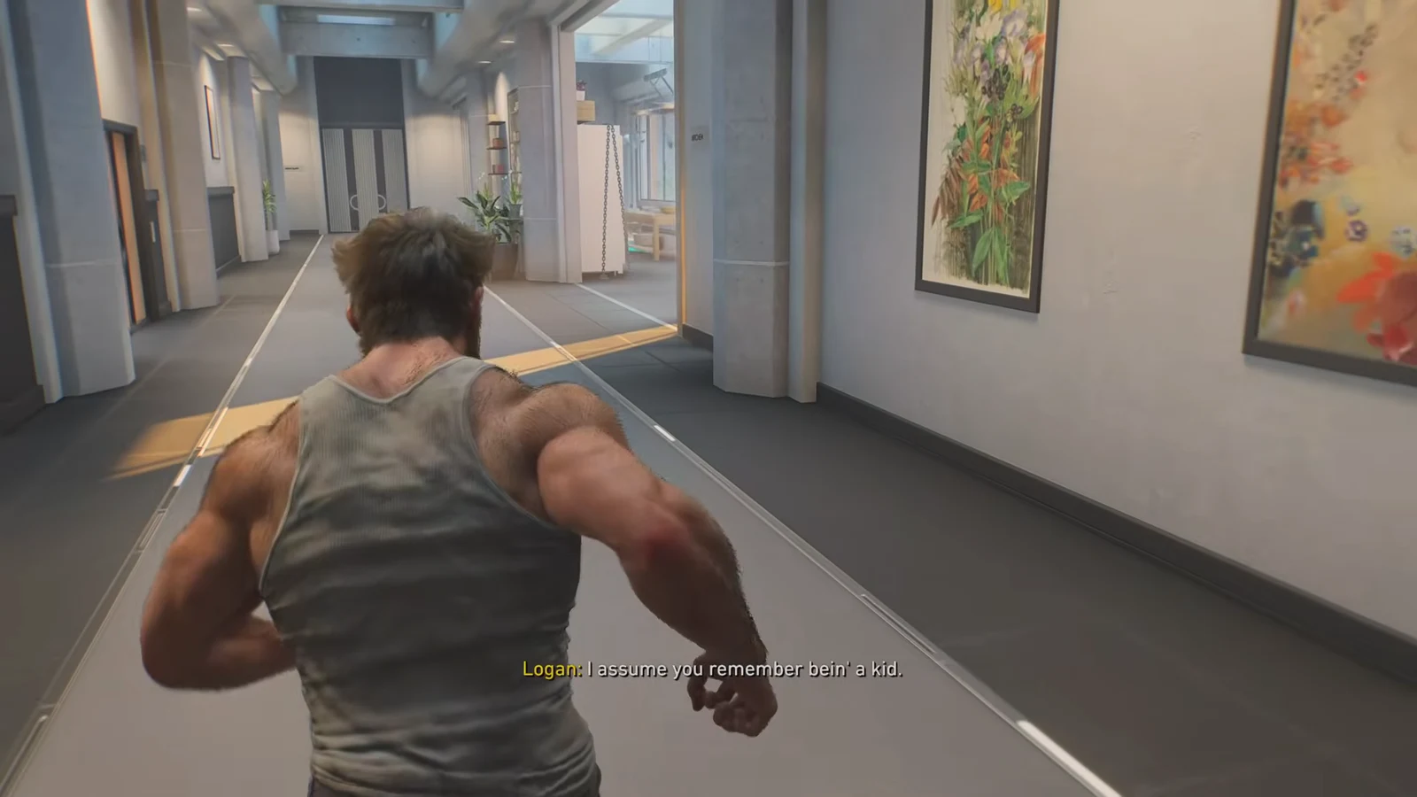 Logan running down an art-lined corridor toward the locker room while Jean talks