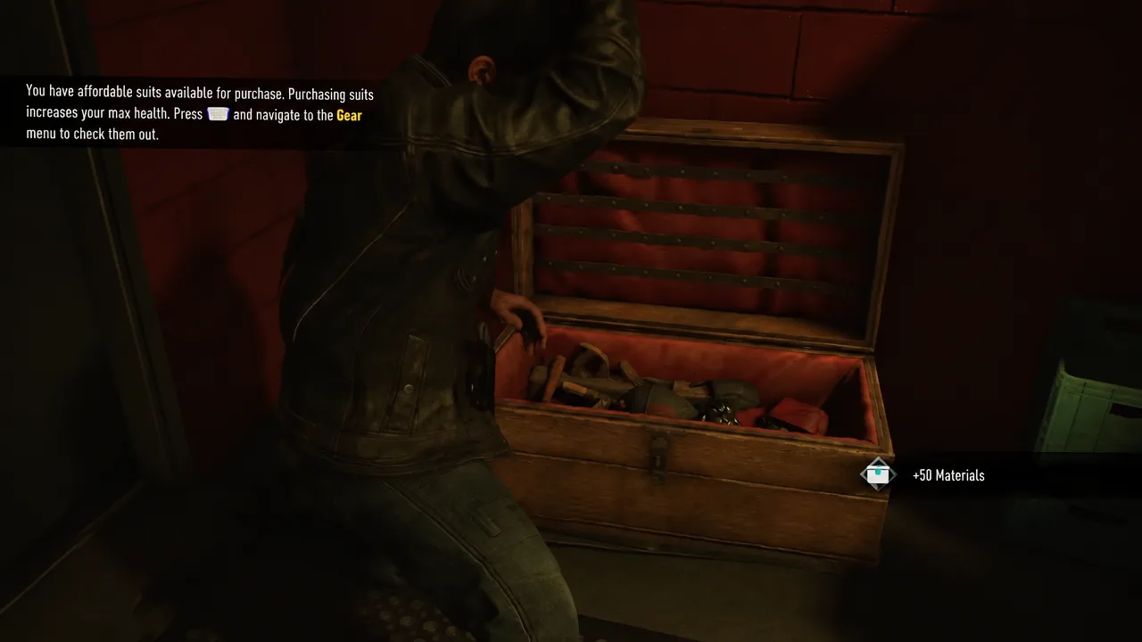 Tutorial prompt pointing to the Gear menu after a Material Crate is opened in Marvel's Wolverine