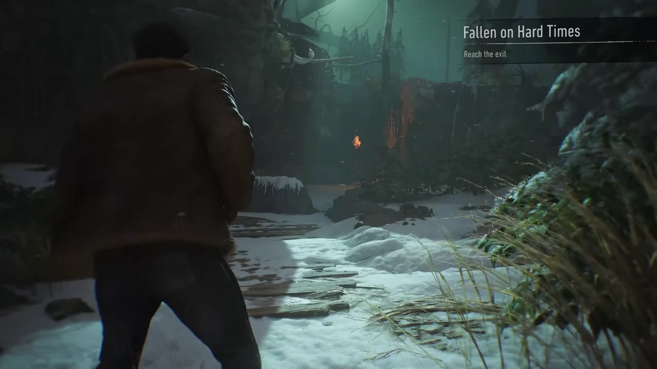 The Fallen on Hard Times trial begins with a Reach the exit objective in a dark snowy forest