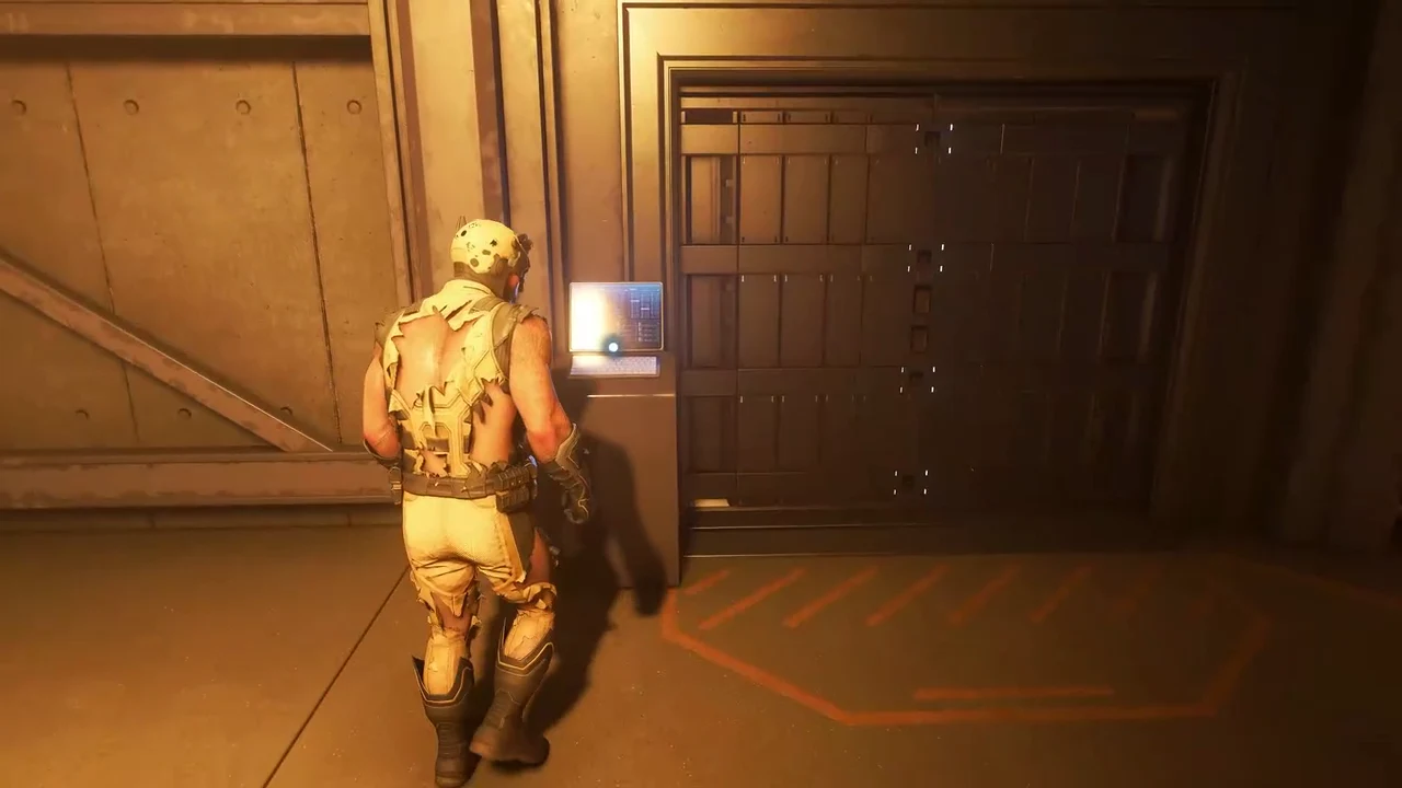 Logan using a wall console to open the sliding metal door in the facility