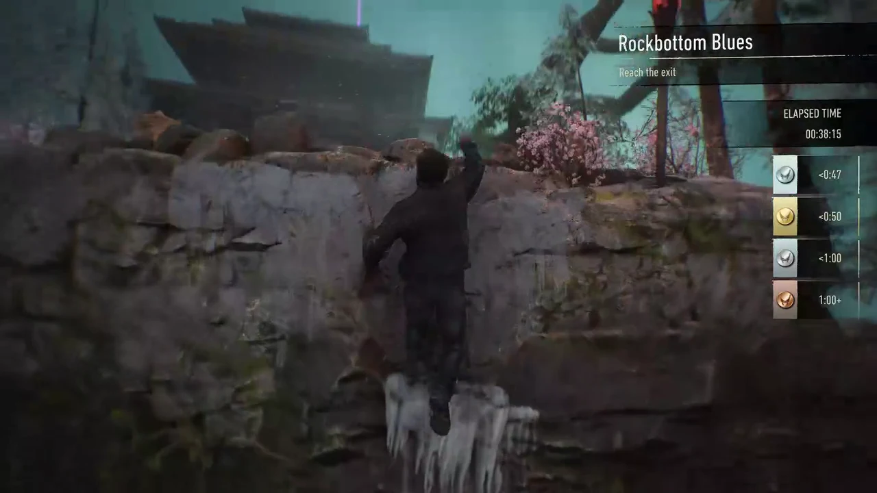 Logan scaling a stone wall with his claws during the Rockbottom Blues traversal course