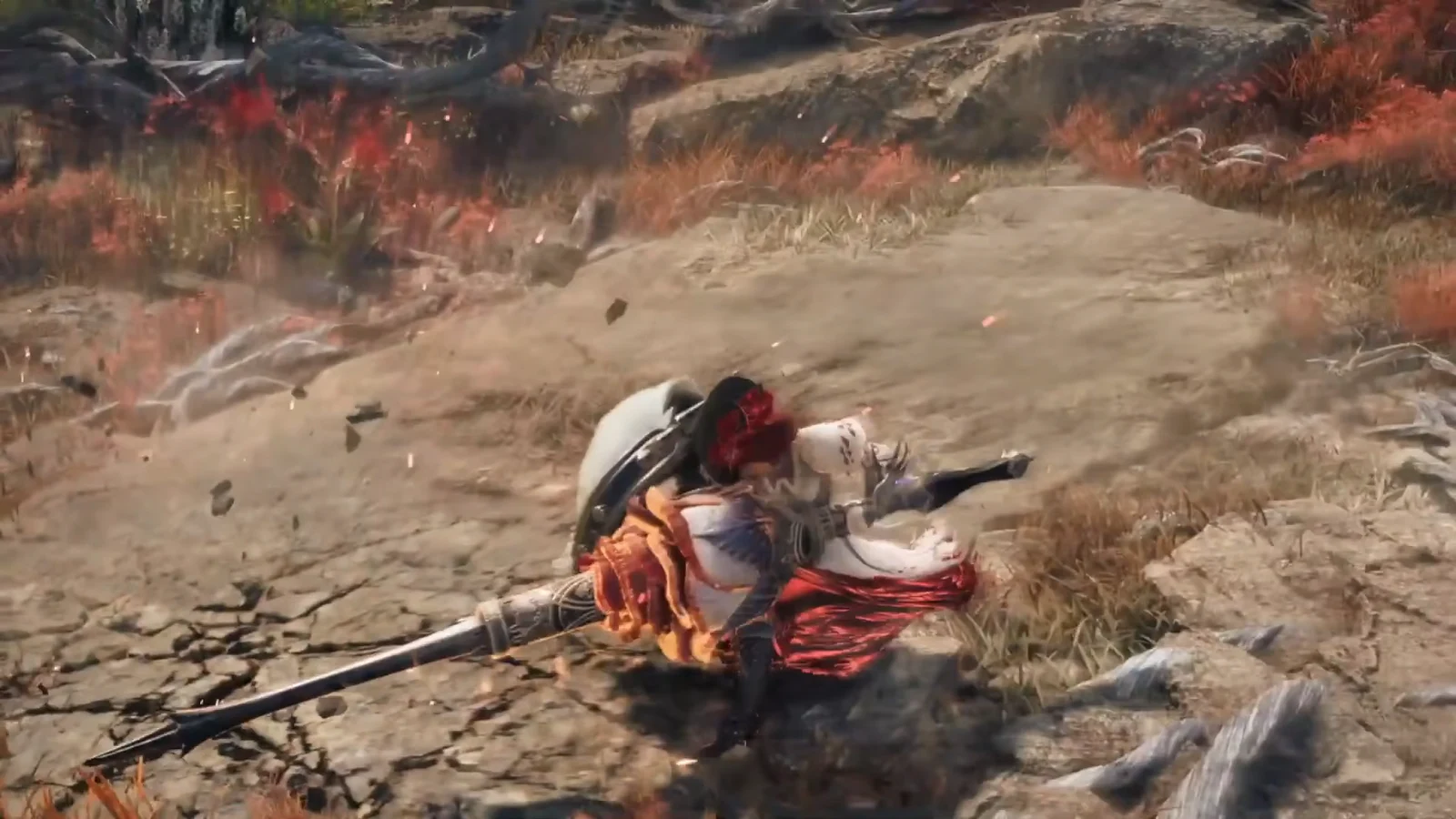 Hunter braced low on a rocky path with a Lance as debris scatters around them