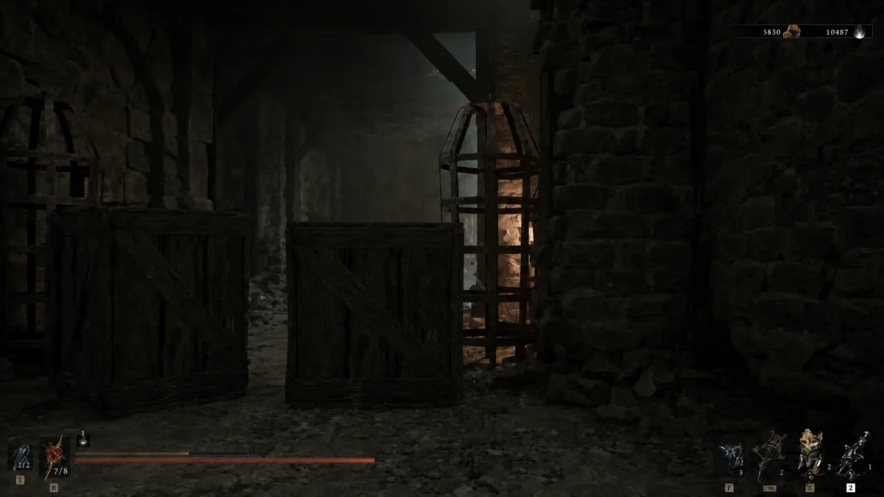 The Harbinger walking past a raised wooden gate and barred doorway inside the dungeon