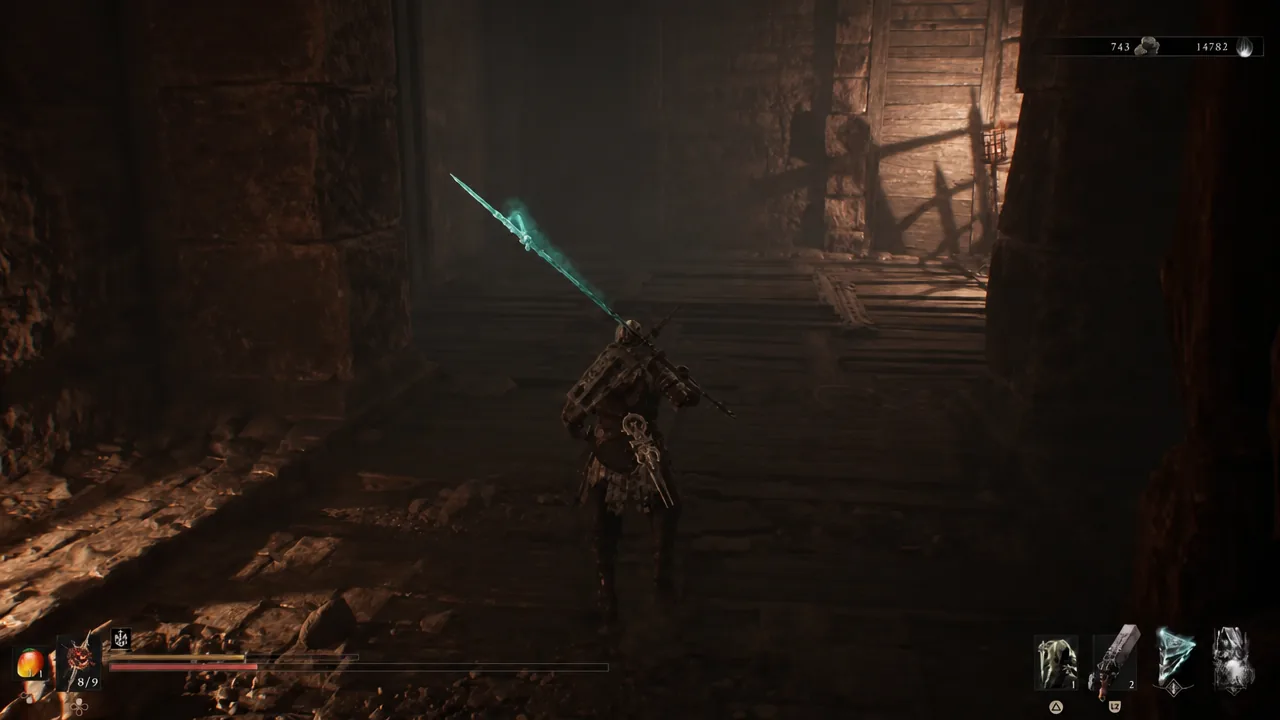 Player moves through a dark underground passage holding a glowing blue blade