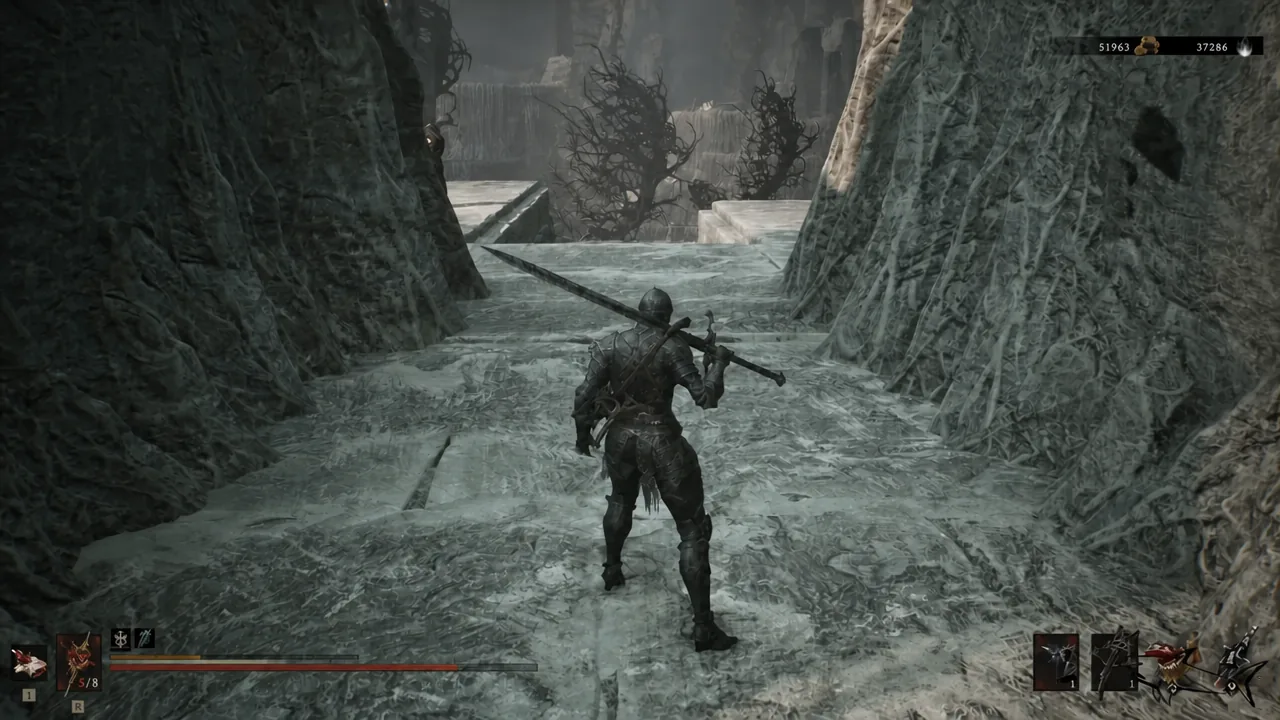 Warrior carrying a large weapon through an icy, root-lined passage near the Forgotten Tower cliffs