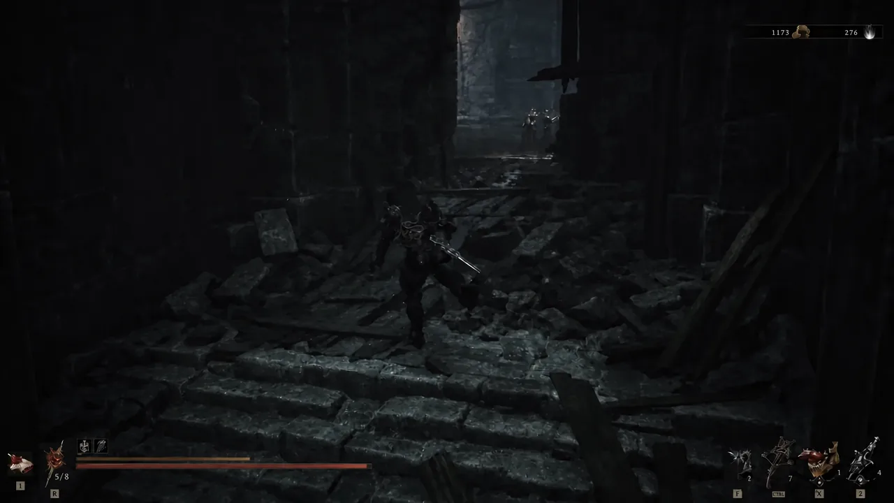 Player advancing down a dark ruined corridor toward an armored enemy inside the tomb