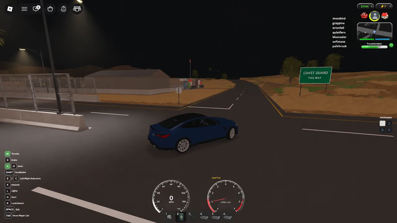 Blue car stopped at the Coast Guard junction on the route to the beach house