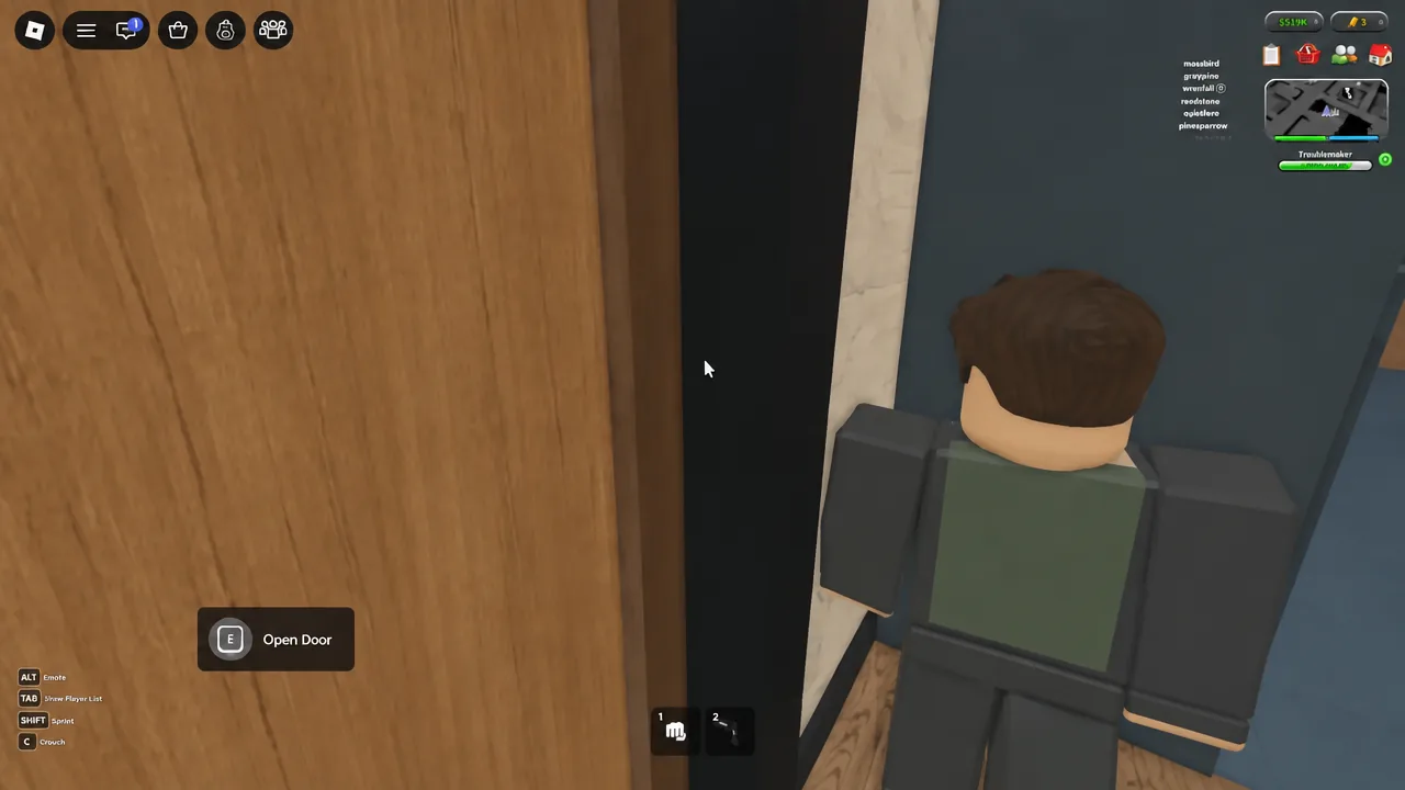The E Open Door prompt highlighted as the player opens an apartment door in the complex.