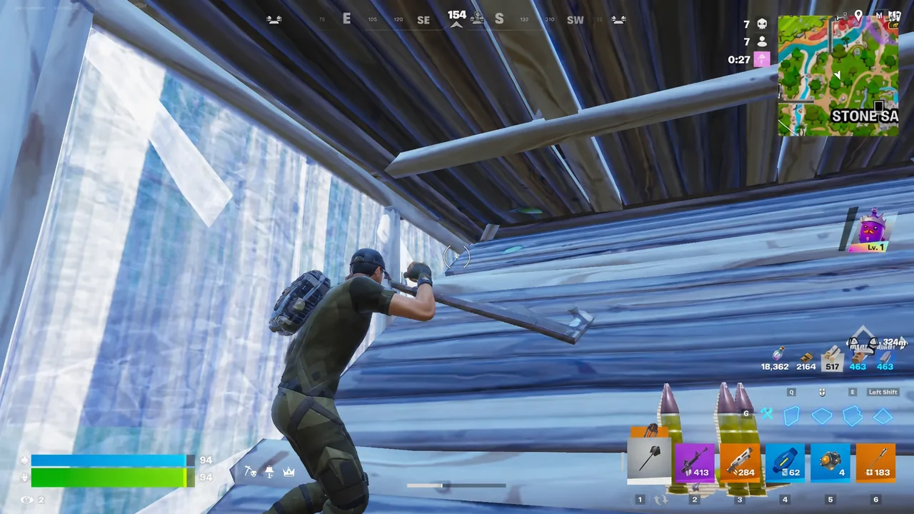 Player swinging a pickaxe inside a wooden structure during a match