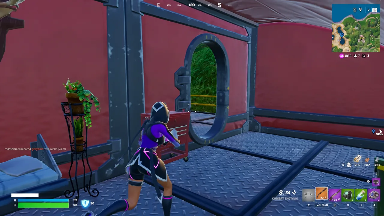 Player holding the Combat Shotgun while approaching an arched doorway inside a building
