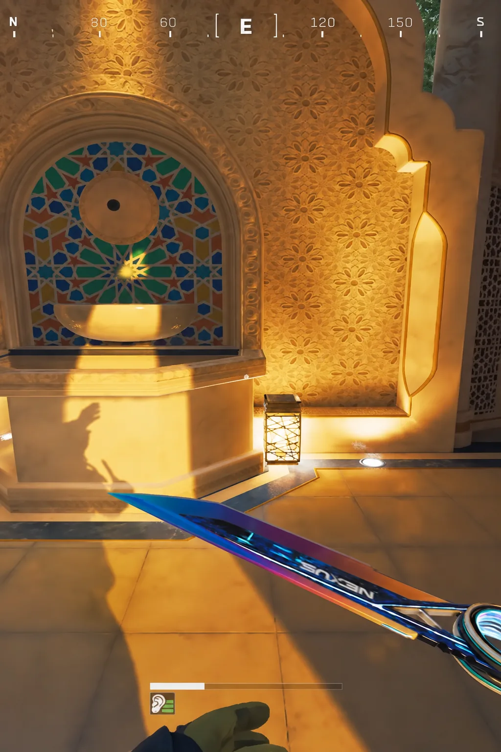 Player standing in front of an ornate illuminated fixture inside the hotel atrium