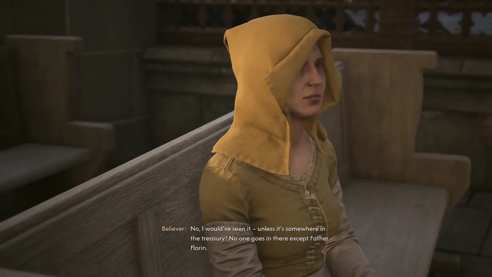 Believer seated in the cathedral talking about the treasury and Father Florin