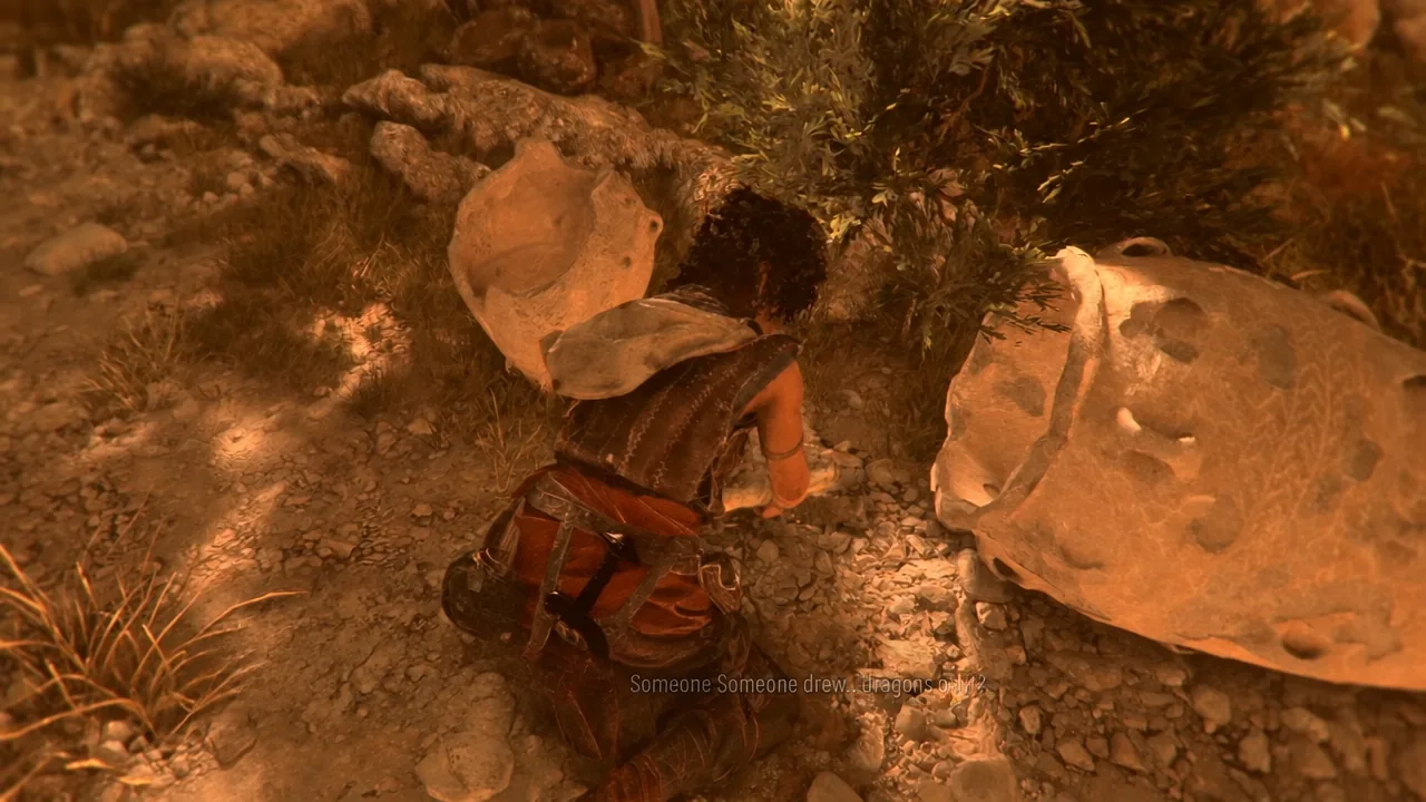 Sophia crouching beside a large rock face to study a painted symbol during the cave section