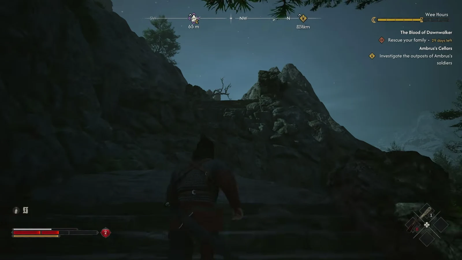 Coen climbs a rocky mountain path with the tracked waypoint 65 meters ahead at night