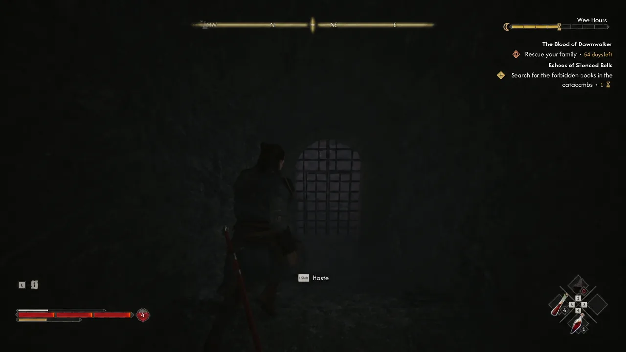 Player moving through a dark catacomb corridor toward a barred gate with the Haste prompt on screen