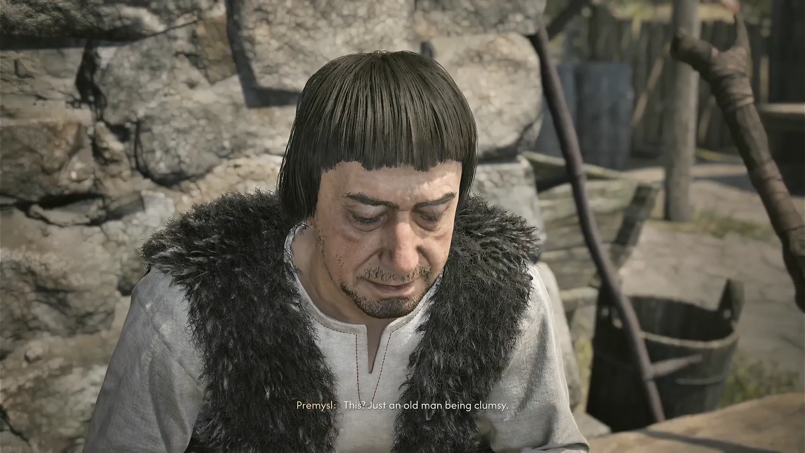 Premysl explains away his injured hand while sitting outside his cabin
