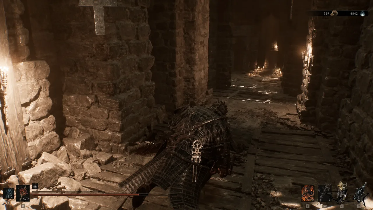 Player moving down a torchlit stone corridor inside Sentry's Grave