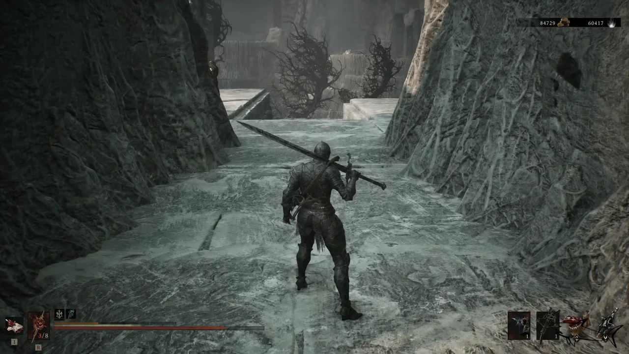 Warrior carrying a large weapon through an icy, root-lined passage near the Forgotten Tower cliffs