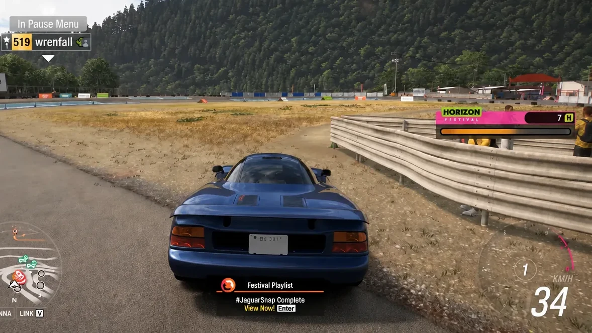 Pause menu showing a #JaguarSnap Complete Festival Playlist notification with a View Now prompt