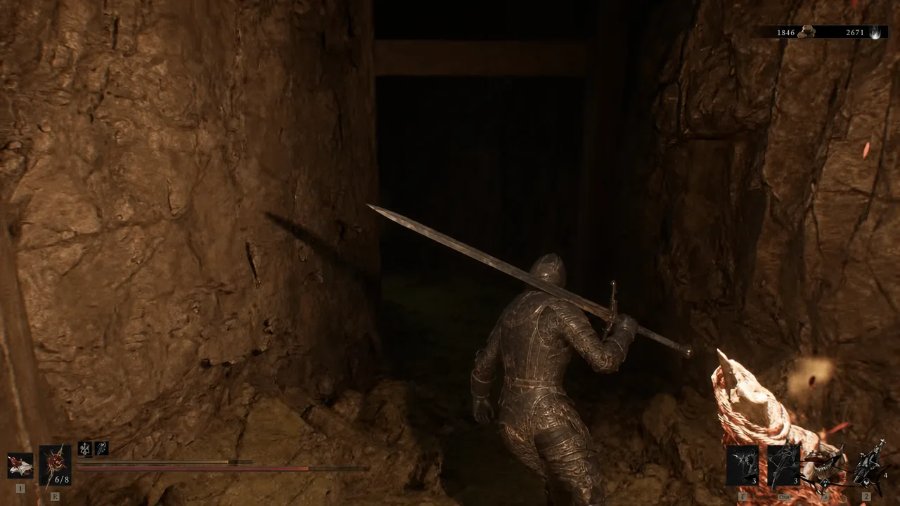 Armored character with a sword moving through a dark stone passage inside the hideout