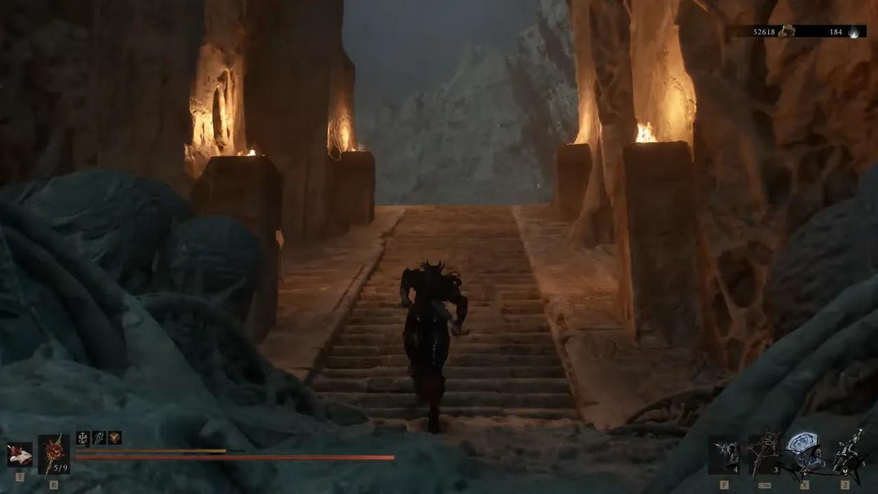 Player character sprinting up a torch-lit stone staircase inside the Ashen Sanctum cavern