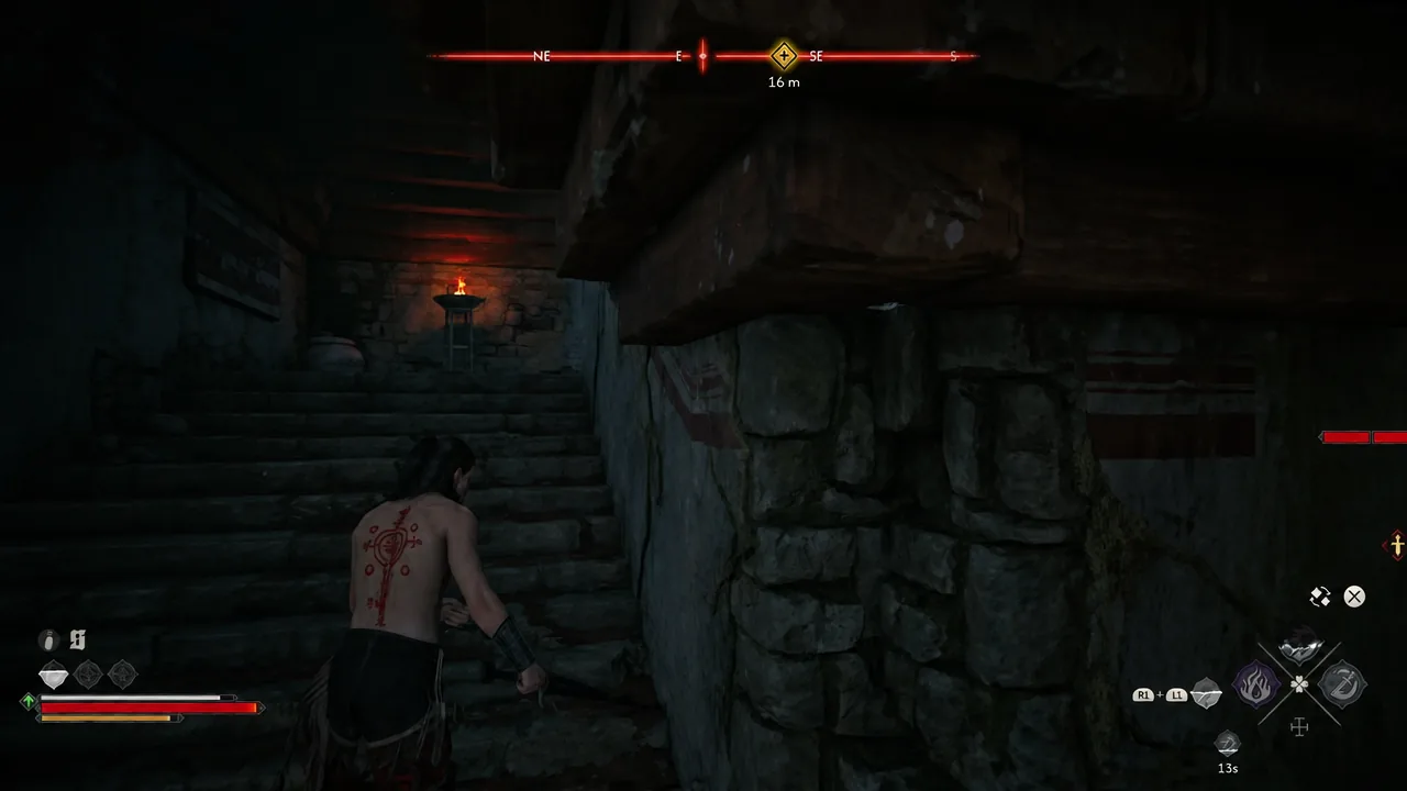 Coen climbing a torch-lit stone stairway with the objective marker 16 metres to the southeast