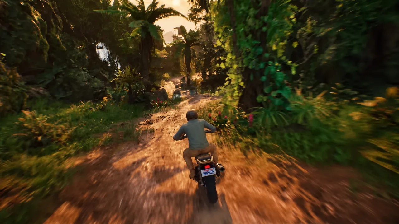 Motorcycle riding down a jungle trail toward open sunlight during a stunt run