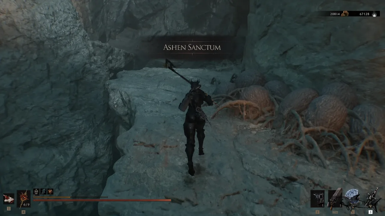 The Ashen Sanctum area title appears on screen as the player runs through the cavern