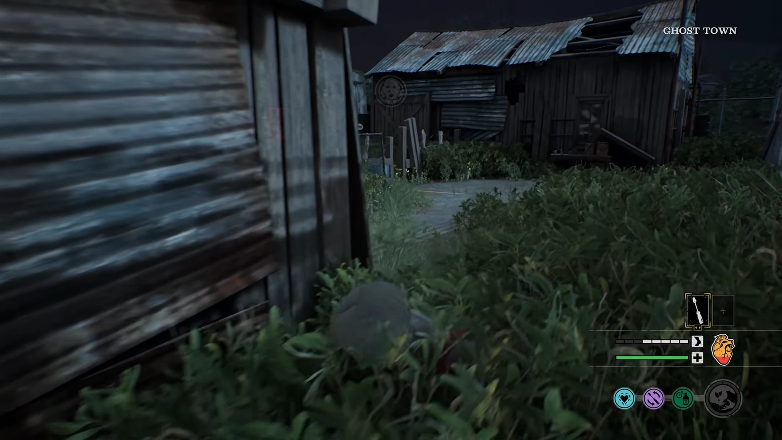 Moving through tall grass toward a wooden shack in the Ghost Town area