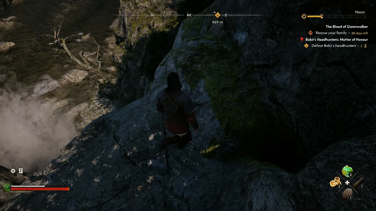 Coen picking his way down a rocky ledge beside the waterfall