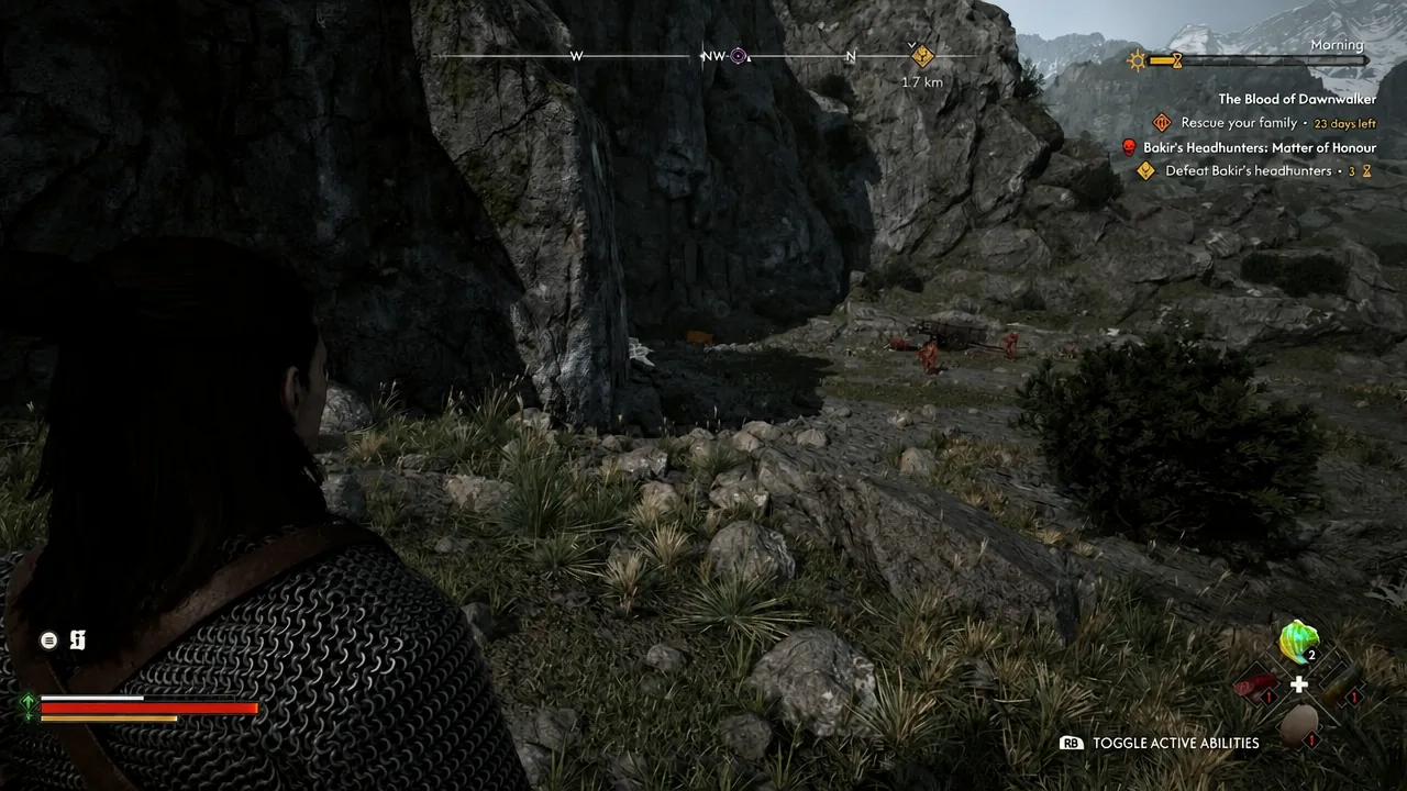 Coen facing hostile creatures on a rocky ledge with the ability toggle prompt on screen