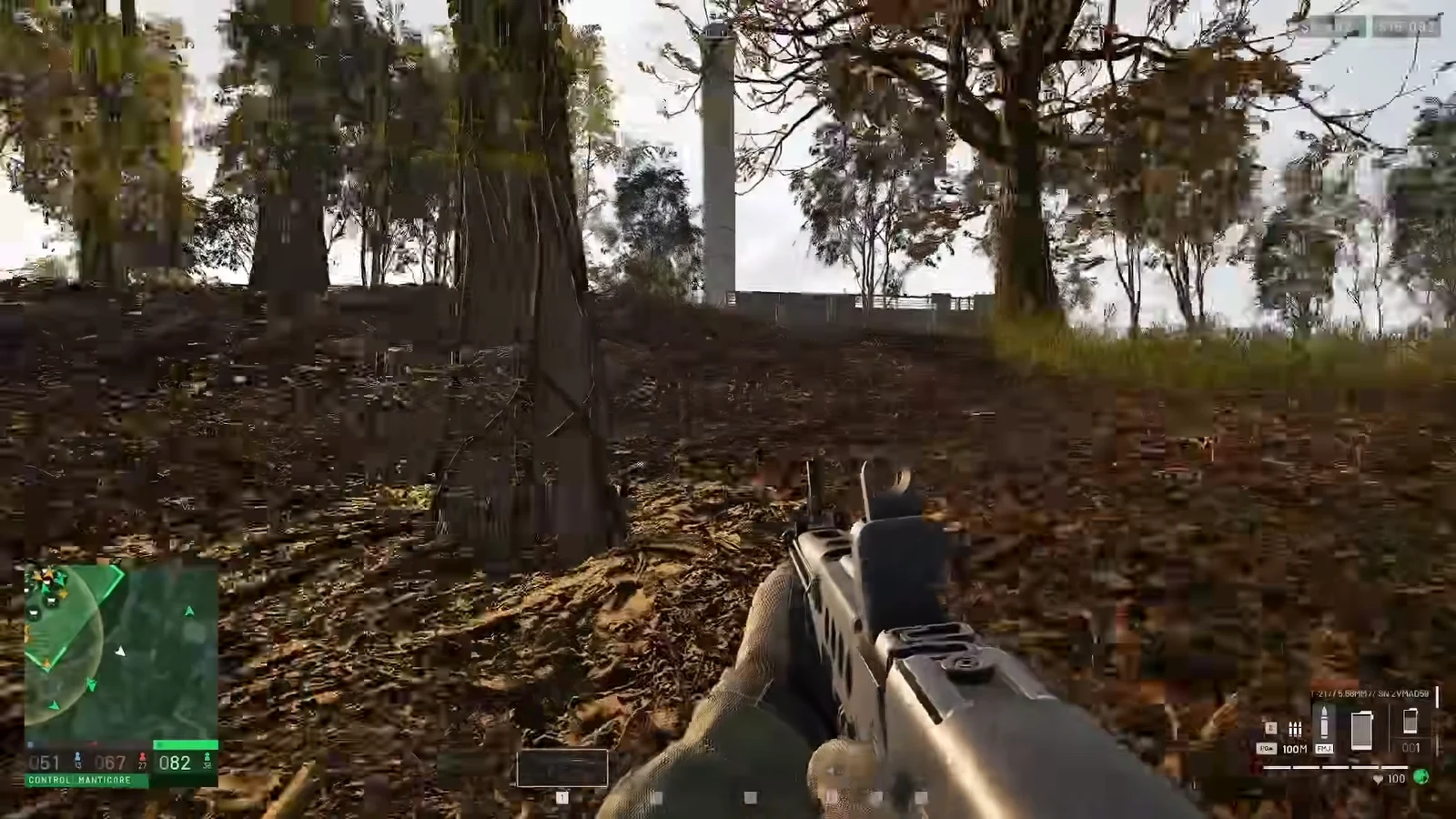 First-person view of a rifle carried through woodland with the minimap and ammo counter on screen