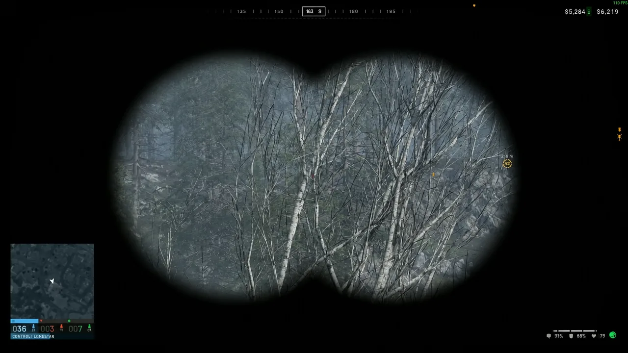 Binocular view scanning a treeline with a marked target at 216 meters